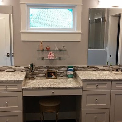 Michael and associates custom bathroom with two vanities and large mirrow