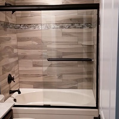 Michael and associates custom bathroom with unique marble and tile with black features