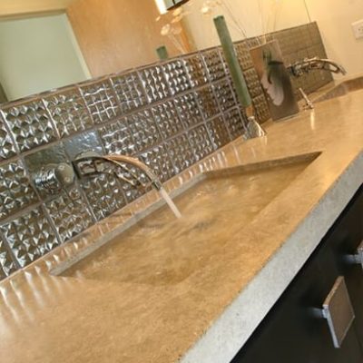 Custom home sinks with marble counter top and metalic backsplash