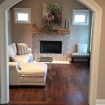 Custom home living room with dark wood floors and tile fireplace