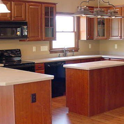 Michael and associates custom kitchen designed with cherry wood and white counters