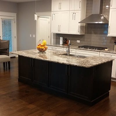 Michael and associates custom kitchen with white cabinets, marble countertops and stainless steel appliances