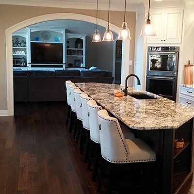 Michael and associated custom home kitchen in white and black marble and white cabinets