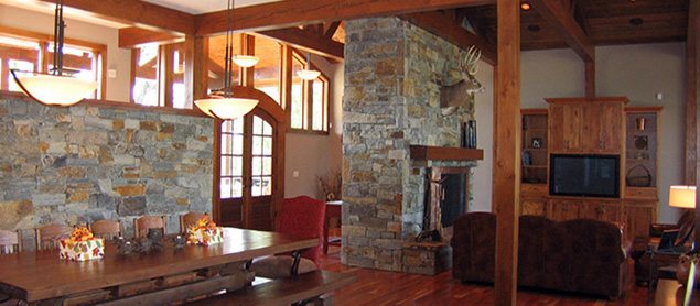 Michael and associates custom rustic living room with wood floors and stone accent walls