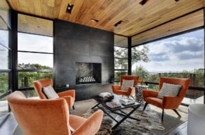 Black-fireplace-and-wooden-roof-for-the-spacious-sunroom