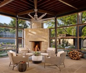 Cozy-sunroom-with-a-limestone-fireplace