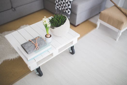 clean design white table with books an plants